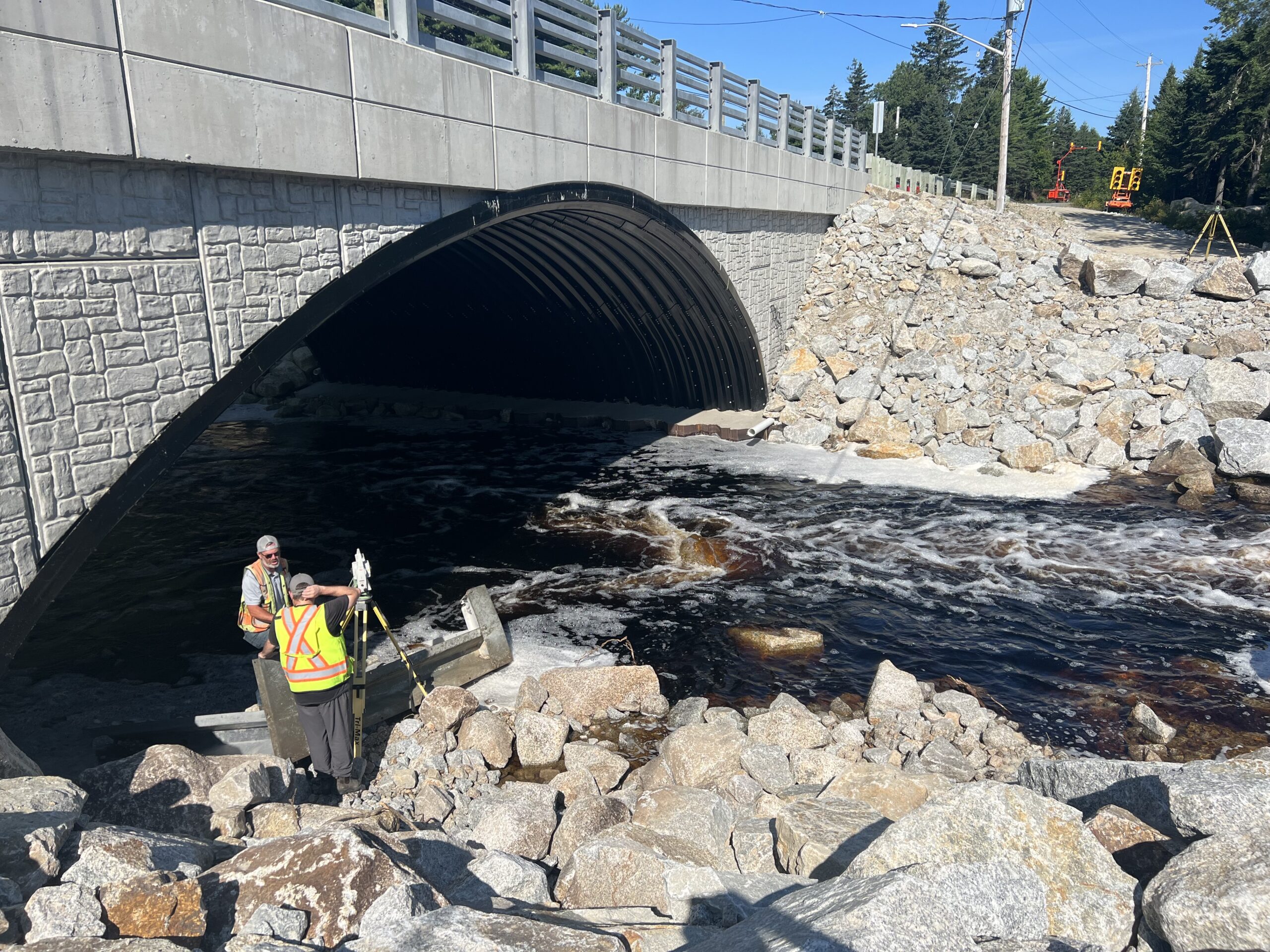 Crew performing detailed total station survey on remediated structure